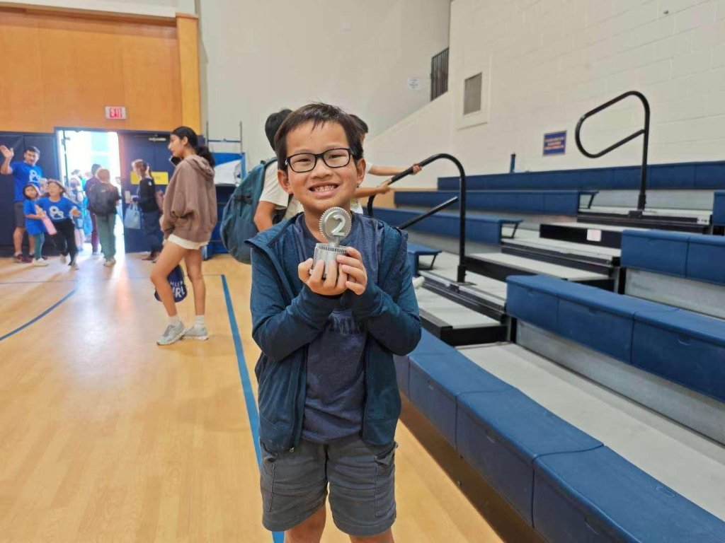 Young champion proudly holding a chess trophy